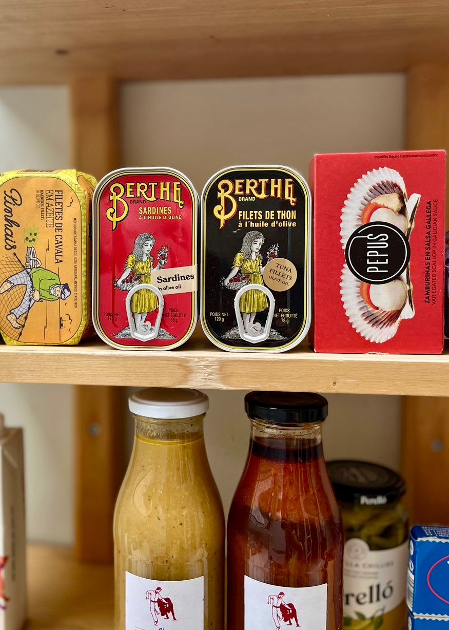 shelf full of colourful tinned fish