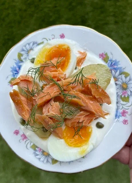 floral plate with sour cream, trout, potatoes, egg and dill