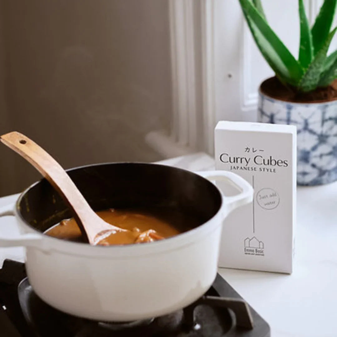 Translation missing: en.Curry cooking in saucepan with packaged curry cubes on kitchen counter: Female Founder Pantry