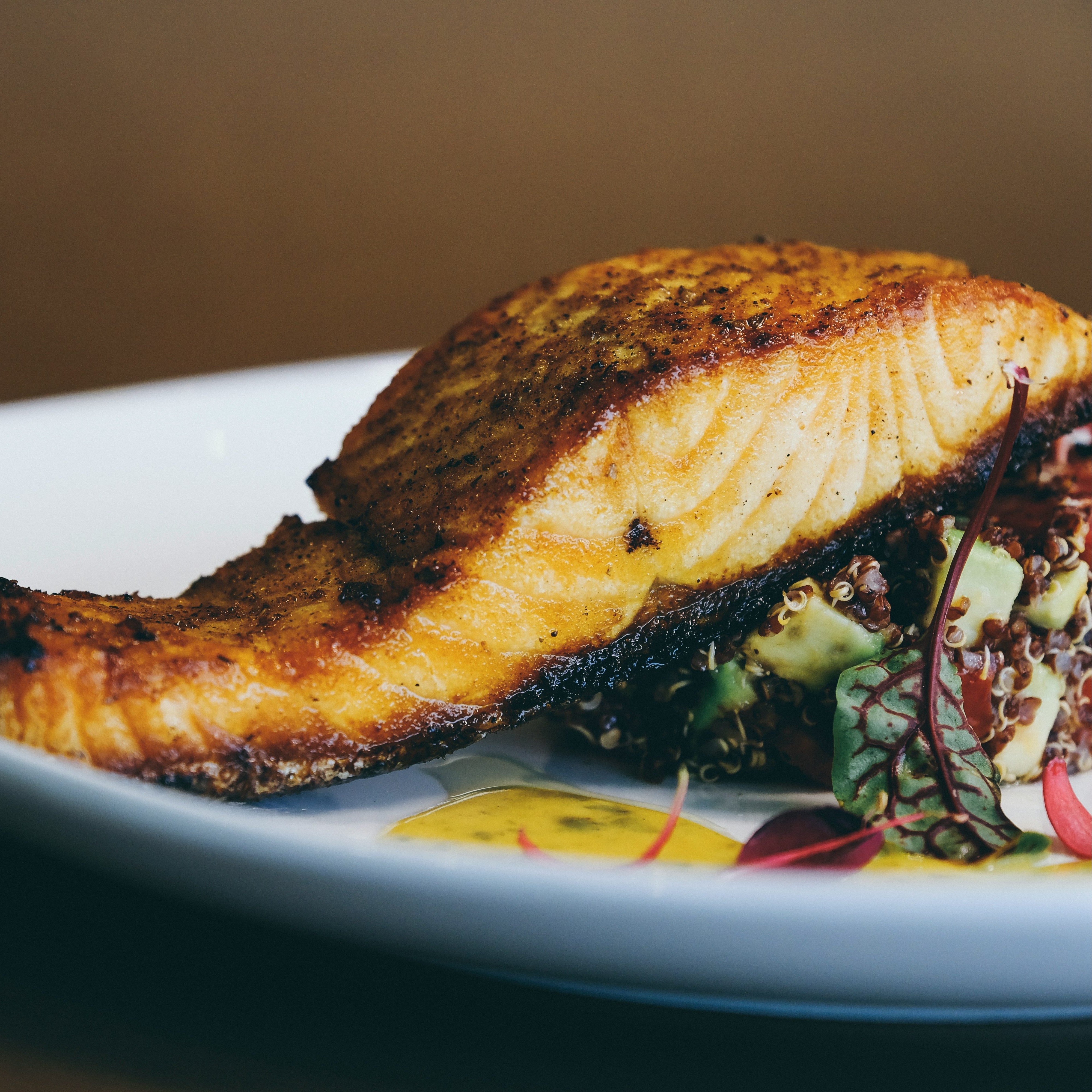 glazed salmon with salad on a white plate