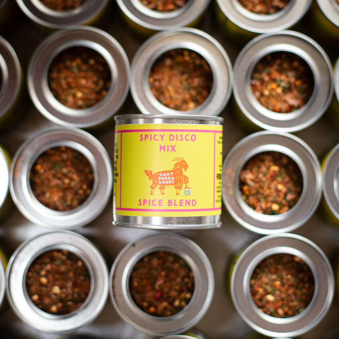 Can of Spicy Disco Mix surrounded by other similar cans on a dark background