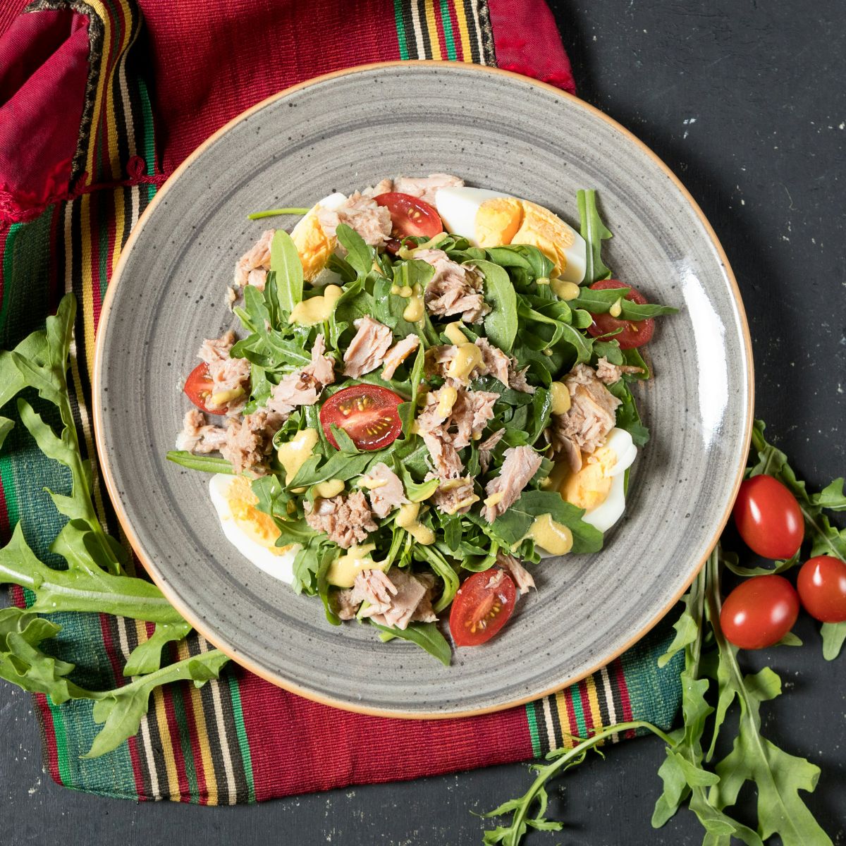 tuna egg salad on colourful picnic blanket