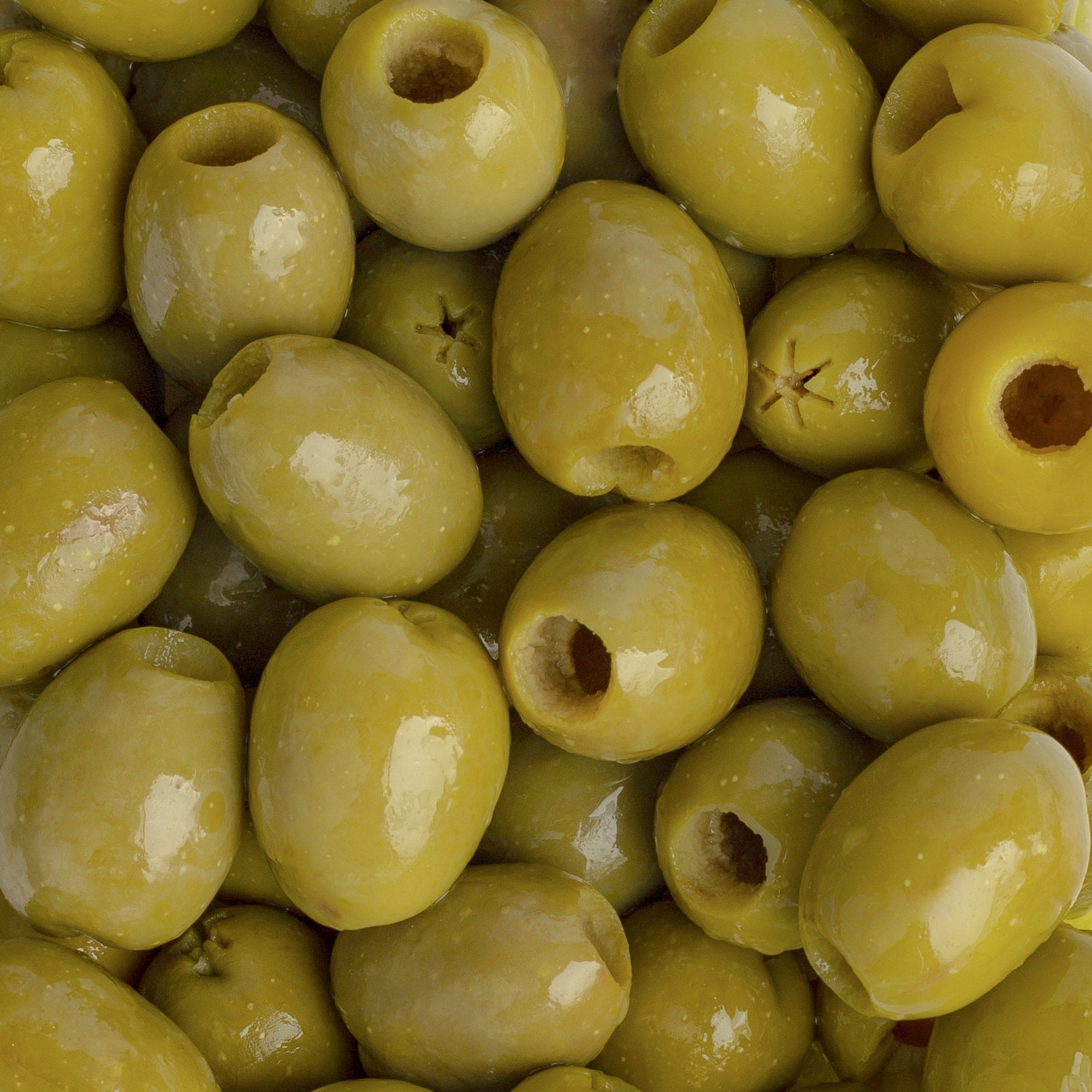 Close-up of green olives with pits